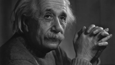 Image of Albert Einstein with his hands clasped together
