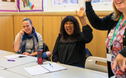 Learner Hub homepage image - three WEA learners in a classroom raise their hands