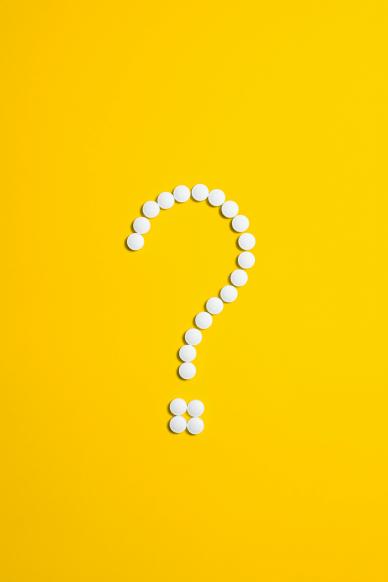 A question mark made of white circles against a yellow background